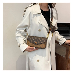 Detail of vintage brown monogram shoulder bag with wide strap and gold hardware