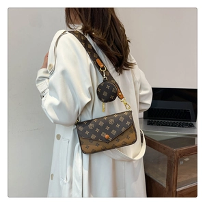 Detail view of retro crossbody bag with patterned wide strap and mini coin purse