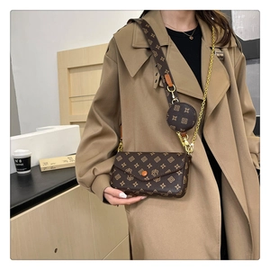 Close-up of brown patterned baguette bag with thick strap and round coin pouch