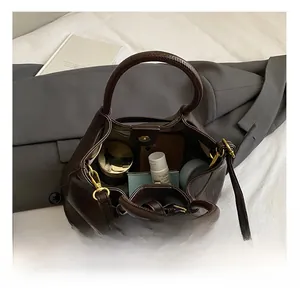 Top view of spacious interior of dark brown leather bucket bag showing storage capacity