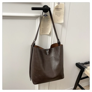 Close-up of vintage dark brown leather tote bag with silver square twist lock detail