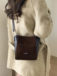 Brown matte leopard print bucket bag with NO FILTER label and adjustable leather strap