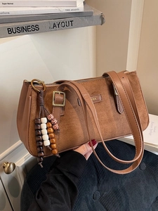 Retro brown suede underarm bag with wooden bead tassel and gold IMA metallic logo