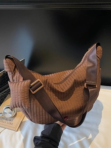 Quilted semi-moon crossbody bag in dark brown with matching wide shoulder strap and coin pouch