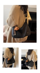 Détail du sac hobo en cuir noir avec logo en métal et porte-clé ours en peluche marron