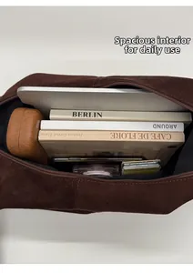 Spacious interior of dark brown suede tote bag showing storage for laptop and books