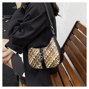 Close-up of retro woven leather pattern on a multi-color patchwork shoulder bag