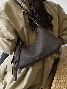 Vintage dark brown leather underarm tote bag with stylish adjustable strap and side tassel
