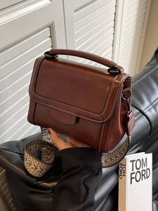 Retro brown leather crossbody bag with contrast stitching and wide woven strap
