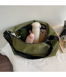 Internal storage view of the green plaid tote bag with daily essentials inside