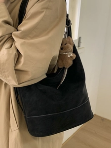 Large black suede tote bag with white contrast stitching and cute puppy pendant accessory