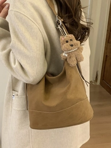 Brown large capacity suede hobo bag with a cute plush dog charm on shoulder strap