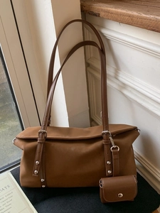Retro brown leather shoulder bag with matching mini pouch and stylish silver hardware