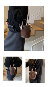 Detail of retro bucket bag featuring brown leather patchwork and scarf-wrapped handle