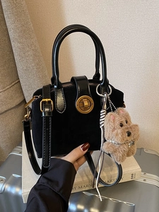 Retro black faux suede shell bag with gold lock, dog charm and adjustable shoulder strap