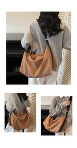 Detail view of large brown checkered tote bag featuring an adjustable black wide shoulder strap