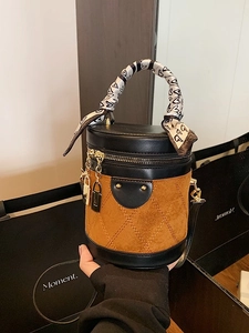 Cylindrical bucket bag with quilted suede paneling and heart print scarf handle
