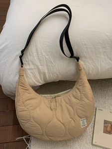 Quilted half-moon shoulder bag in beige with adjustable strap and wave pattern
