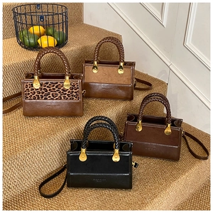 Macro shot of stylish mini tote bags in leopard print and leather with woven handles