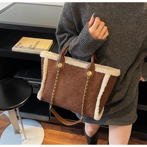 Brown faux suede tote bag with cream fleece trim and decorative gold metal chains