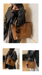 Close-up of brown suede tote bag featuring fuzzy pom-pom and wooden bead tassel details
