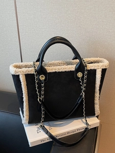 Chic black matte tote bag with beige faux shearling trim and chain shoulder strap