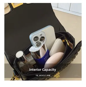 Interior capacity of quilted shoulder bag holding phone, perfume and cosmetics
