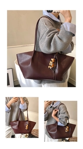 Detail of dark brown tote bag with beaded tassel and long leather shoulder straps