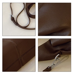 Detailed macro view of dark brown litchi grain leather texture and silver hardware buckles