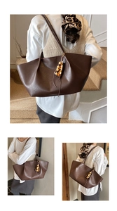 Detailed view of dark brown tote bag with pleated top and wooden bead tassel decoration