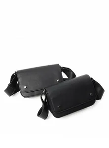 Detailed close-up of two black cross-grain leather crossbody bags with silver stud accents