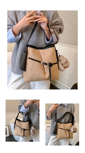 Detail view of a vintage beige bucket bag with pleated texture and plush bunny charm