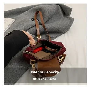 Interior capacity of burgundy nylon crossbody bag showing phone and lipstick storage