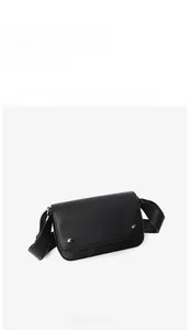 Front angle view of minimalist black square crossbody bag with dual silver buckles