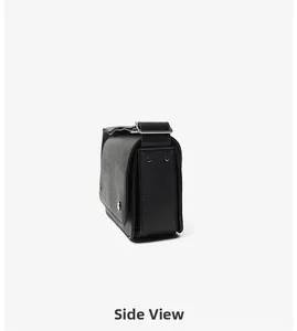 Side view of black crossgrain leather crossbody bag with silver hardware and adjustable strap