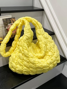 Bright yellow quilted cloud shoulder bag with puffy texture and silver metal zipper