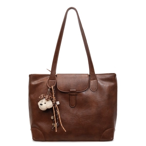 Deep brown retro tote bag with smooth PU leather finish and a cute plush puppy keychain