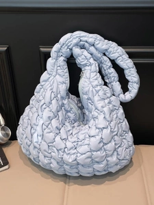 Light blue quilted cloud bag with padded texture and stylish top handle for women