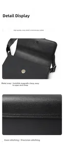 Detail of black crossgrain leather bag showing metal magnetic buckle and precise stitching