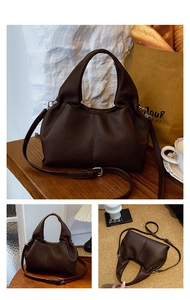 Detailed macro view of dark brown pebble leather texture and pleated dumpling bag design