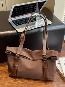 Brown large capacity tote bag with leather straps and unique folding flap design