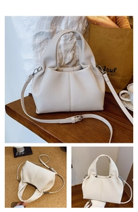 Detail of creamy white dumpling bag showing lychee grain leather texture and strap