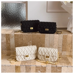 Chic quilted crossbody bags in black and beige with elegant gold chain strap and turn-lock