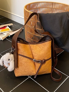 Vintage brown pleated bucket bag with large capacity and cute plush rabbit charm accessory