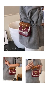 Detail of burgundy lace crossbody bag with bear embroidery and plush handle decoration