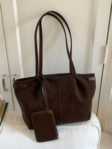 Large dark brown matte tote bag with shoulder straps and matching small pouch