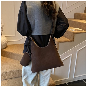 Detail of vintage large capacity brown tote bag and mini pouch in a soft suede finish
