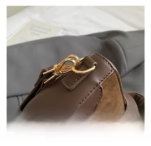 Detail shot of brown leather bag showing premium gold metal hook and fine stitching