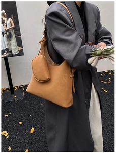 Detail of vintage brown tote bag with matching zip pouch shown on model