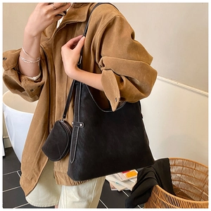 Large black suede tote bag with white contrast stitching and a round coin purse detail